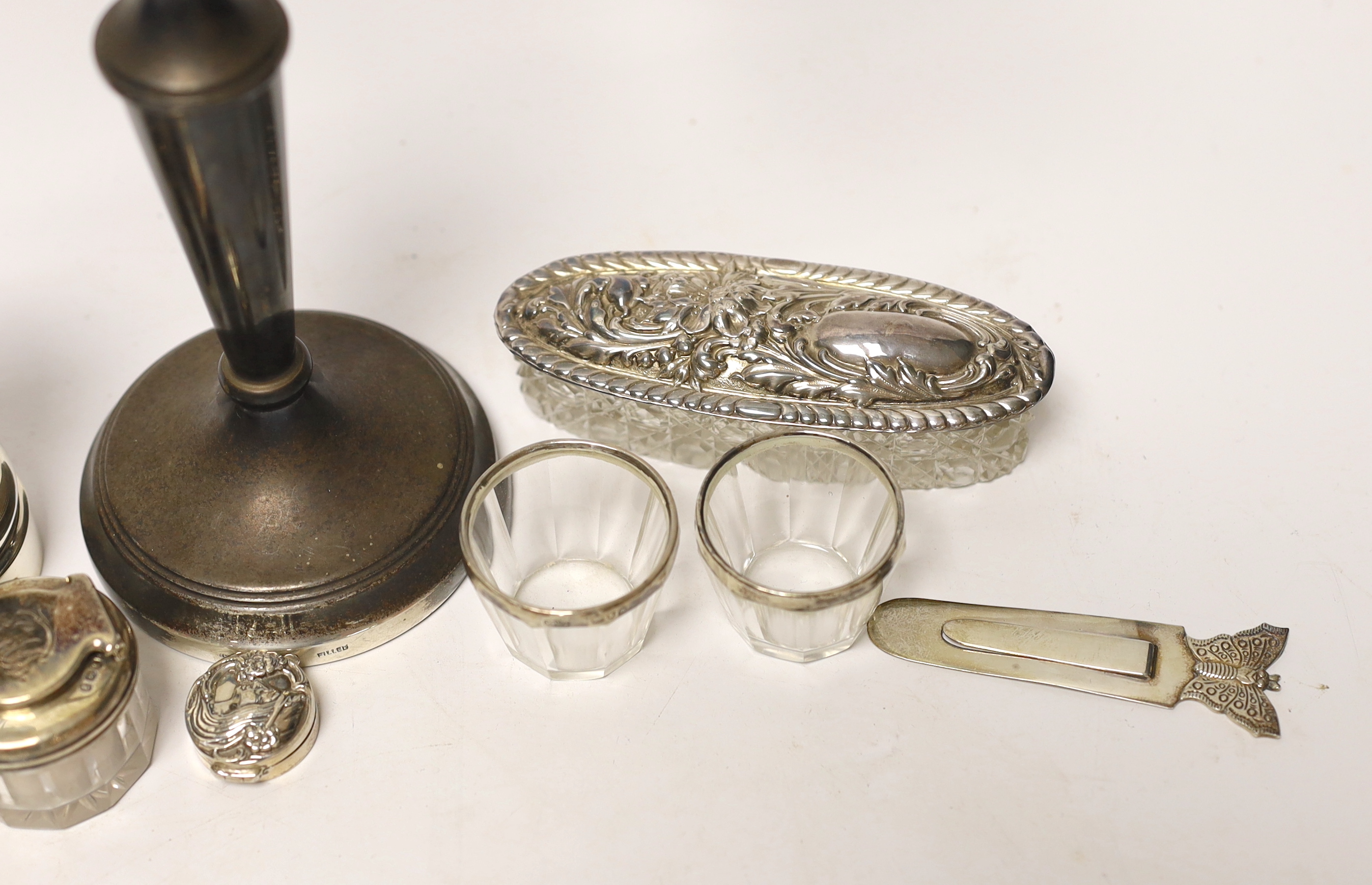 A group of mixed silver including a modern candelabrum, toilet jars and a pepper grinder.